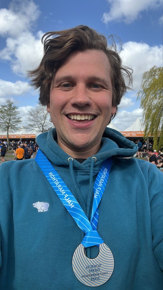 Thomas smiling with his half marathon finisher medal